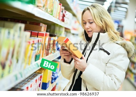 woman choosing bio produces during food shopping in grocery store supermarket