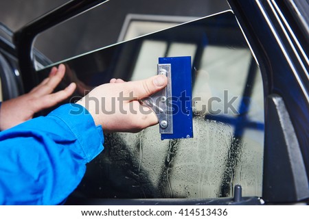 car tinting. Automobile mechanic technician applying foil