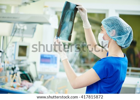intensive care unit female doctor with x-ray image