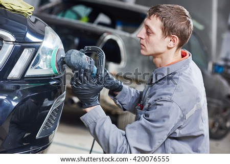 auto mechanic buffing and polishing car headlight