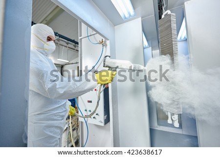 industrial metal coating. Man in protective suit, wearing a gas