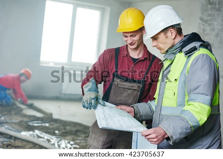 foreman builder and construction worker with blueprint in indoor apartment