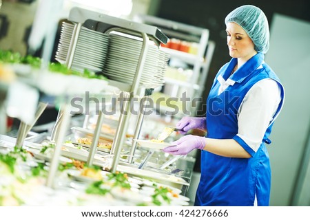 buffet female worker servicing food in cafeteria