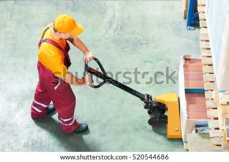 worker with fork pallet truck