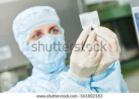 Pharmacy production. factory woman examining bottles with medicine
