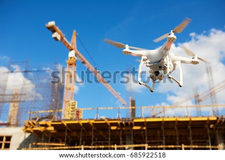 Drone over construction site. video surveillance or industrial inspection
