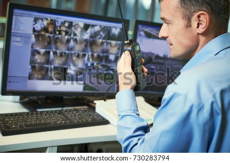 Security worker with radios. Video surveillance system.