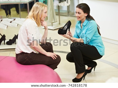 man and assistant at shoe shopping