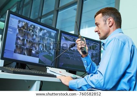 Security worker during monitoring. Video surveillance system.