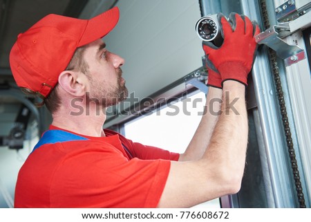 worker installing video surveillance camera