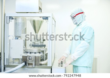 Worker operating pharma capsule filling machine