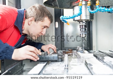 mechanical technician operative of cnc milling cutting machine center at tool workshop