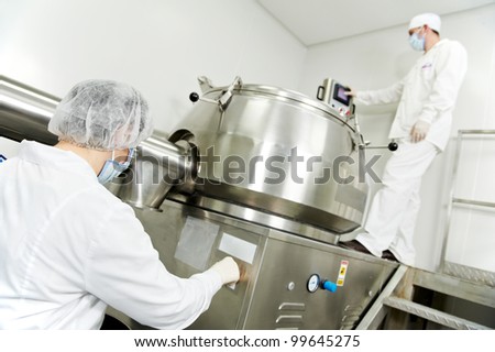 pharmaceutical factory worker at pharmacy industry manufacture with mixer granulator