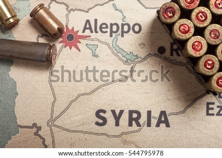 Interpretation on konflikt in Syria. The fired cases and bullets from rifle. Background view on section area of Aleppo, Syria.
