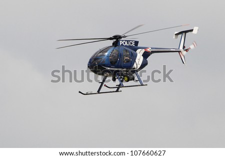 KECSKEMET, HUNGARY - AUGUST 7, a MD-500 police helicopter flies at the International Air and Military Show on August 7, 2010 in Kecskemet, Hungary