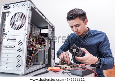 The technician put the CPU cooling fan on the computer mainboard. the concept of computer hardware, repairing, upgrade and technology.