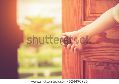 Women hand open door knob or opening the door.