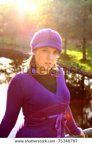 beautiful woman in an autumn park  with beautiful light and sun flare