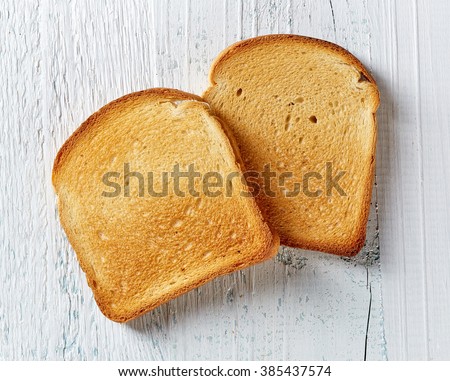 Slices of toast bread on wooden table, top view