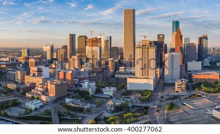 Aerial panorama view of downtown Houston, Texas as seen from the near northeast side.  New construction in this growing portion of the city is illuminated in early morning sunlight.