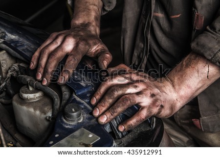 Working men with dirty hands stay near car engine
