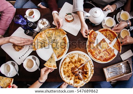 company of people eating pizza. top view