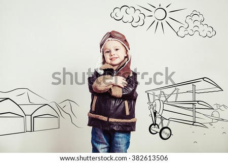 Happy kid against drawn airdrome and skies. Profession collection.