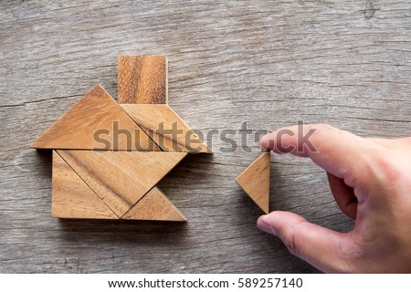 Wooden tangram puzzle wait to fulfill home shape for build dream home or happy life concept
