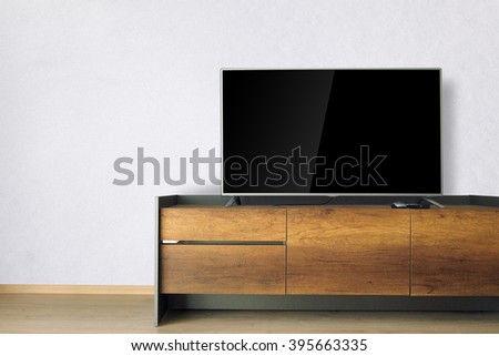 Led TV on TV stand with white wall
