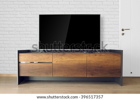 Led TV on TV stand with brick wall in the living room