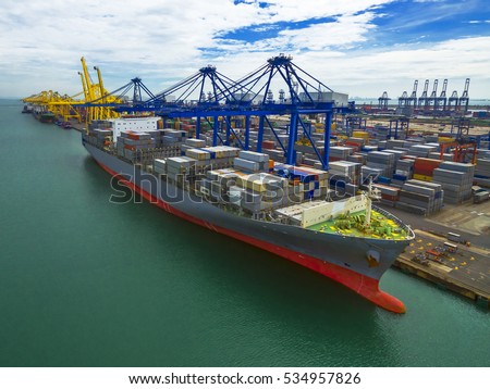 Port shipping Use crane lifting containers in ship break-bulk carrier by sea of Thailand .