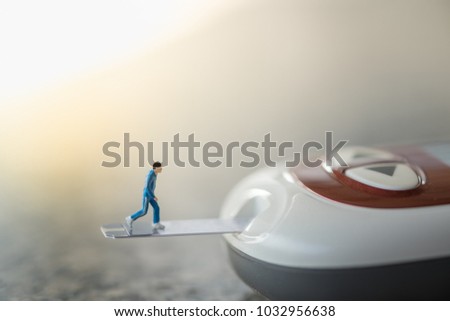 Medicine, diabetes, glycemia, health care and people concept - close up of runner miniature figure running on blood sugar test strip and connect to Glucose meter