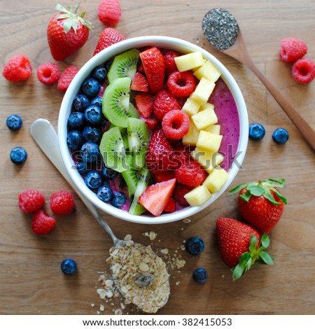 Healthy and colorful breakfast acai smoothie bowl with fruit toppings