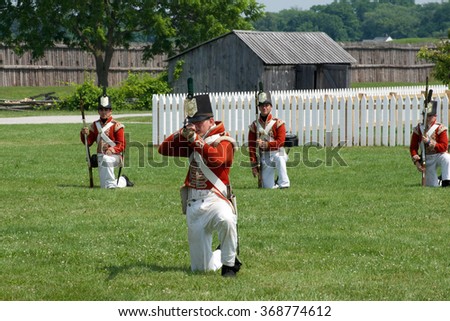 Niagara on the Lake, Ontario, Canada - July 13, 2015: A squad of soldiers practice traditional British Army battle drills at Fort George Historic Site.