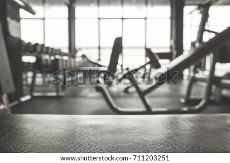 Fitness Gym background.Focus on the Bench and blurred Gym equipment