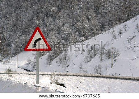 danger right turn traffic in snow covered road - winter landscape