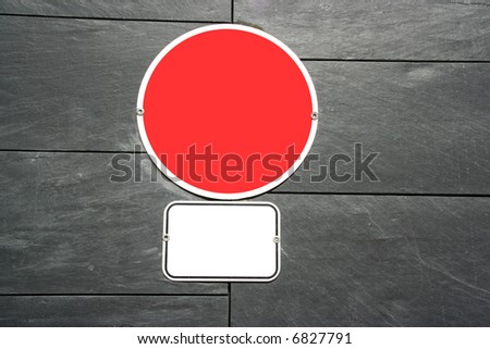 two empty signs in textured granite wall