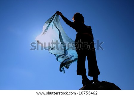 silhouette of a woman with blue scarf - symbol of freedom