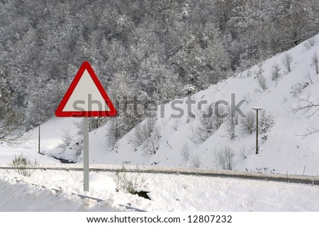 danger empty traffic signal in snow covered road - winter landscape