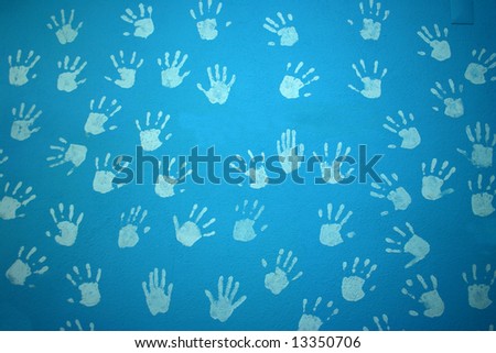 blue textured wall with child hands print