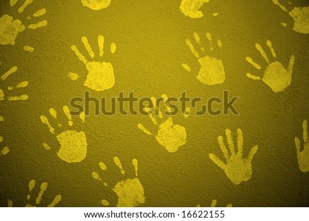 yellow textured wall with child hands print