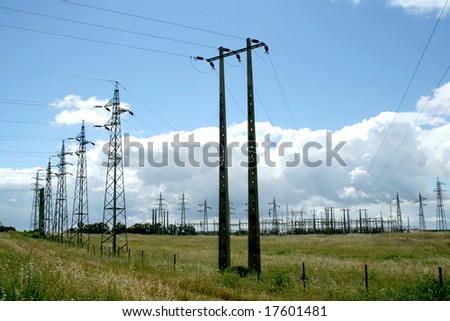 electric power station in the field in blue cloudy sky