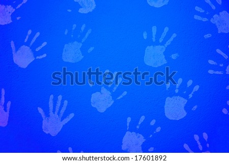 blue textured wall with child hands print