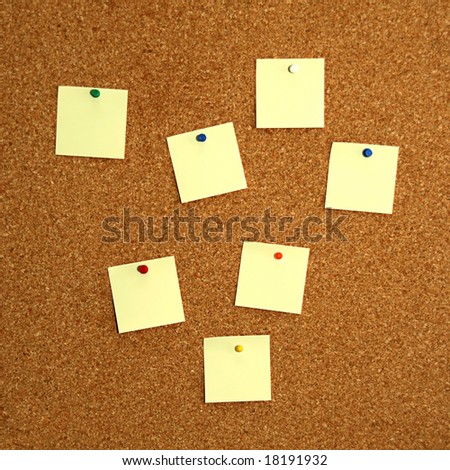 square cork board with seven empty yellow notes