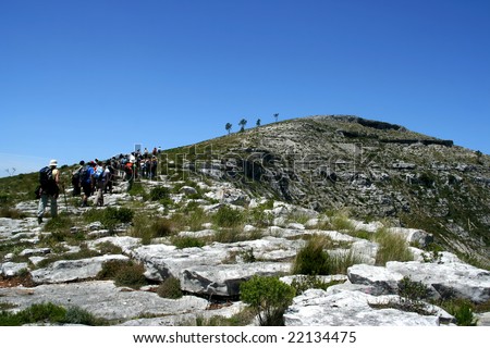group of walkers climbing mountain - editorial use