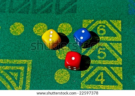 three dice with number one, two, three in green table game