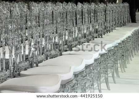Close up of elegant contemporary designed plastic chairs, crystal look, boken, close up