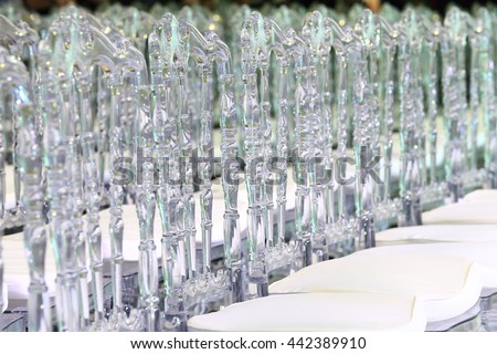 Close up of elegant contemporary designed plastic chairs, crystal look, depth of field, out of focus