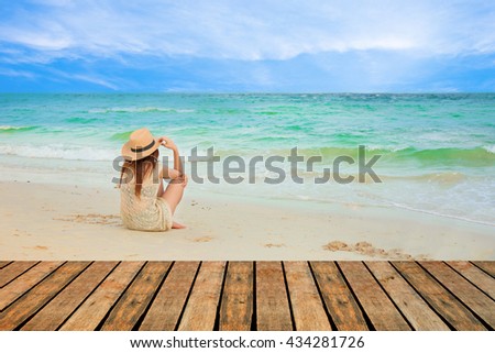Fashion  of asian beautiful girl  with hippie outfit and hat outdoors at sunset on the sea. Soft warm color tone. Boho lifestyle. Bohemian Style.