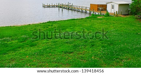 A fishing pier/boat dock with a shed and cleaning station over the Piankitank river in Middlesex county Virginia.